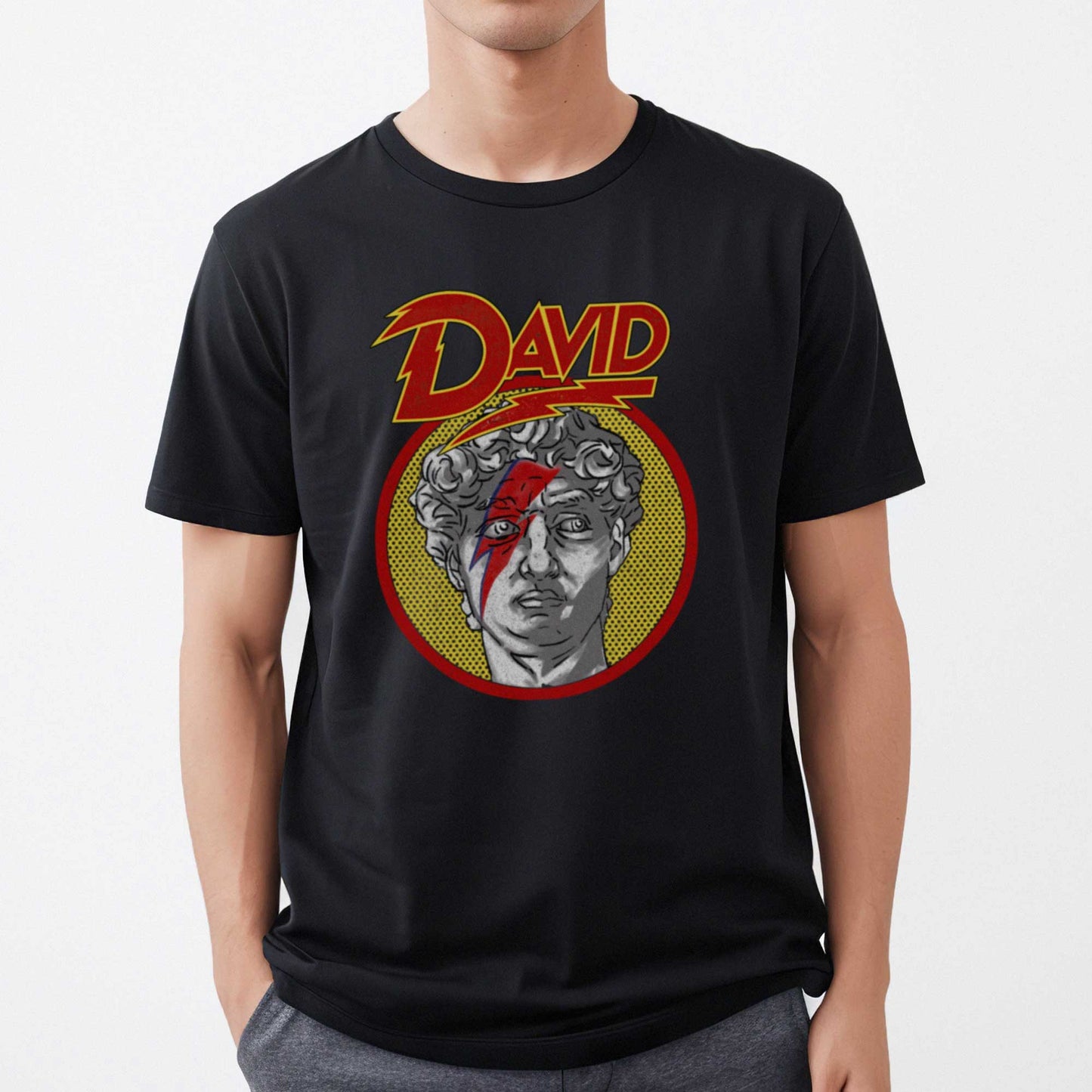 A man wearing a vintage black Bella Canvas t-shirt featuring the face of Michelangelo's sculpture of David with a lightning bolt across his face.