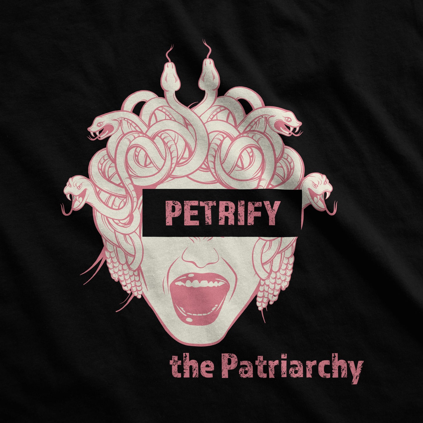 A black District 7501 swatch featuring the face of Medusa with a block of letters over here eyes that says petrify and the words the patriarchy below.