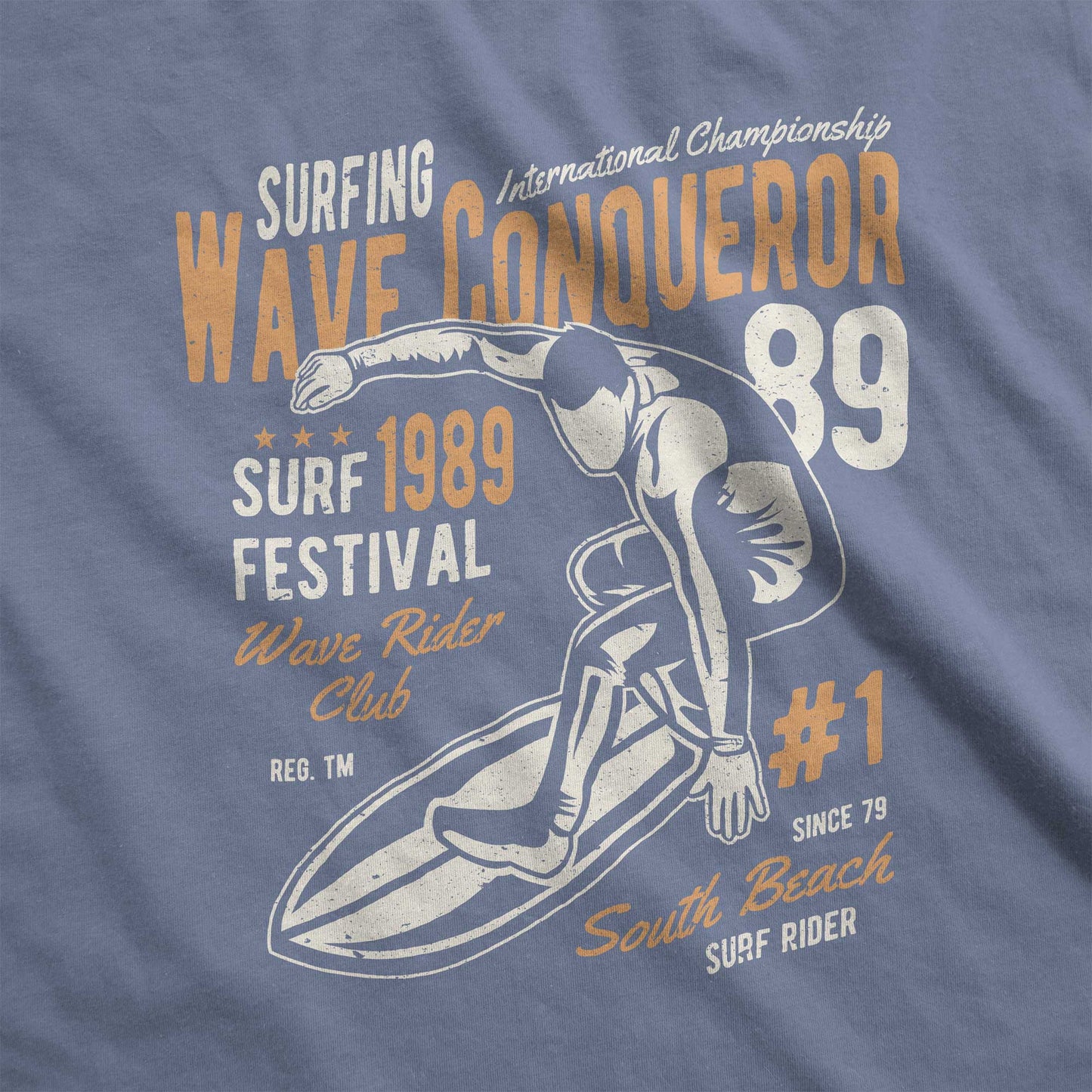 A blue jean Comfort Colors swatch featuring a man riding a surfboard and the words wave conqueror