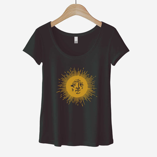 A hanging black District 7501 scoop neck t-shirt featuring a medieval woodcut illustration of the sun with a face inside.