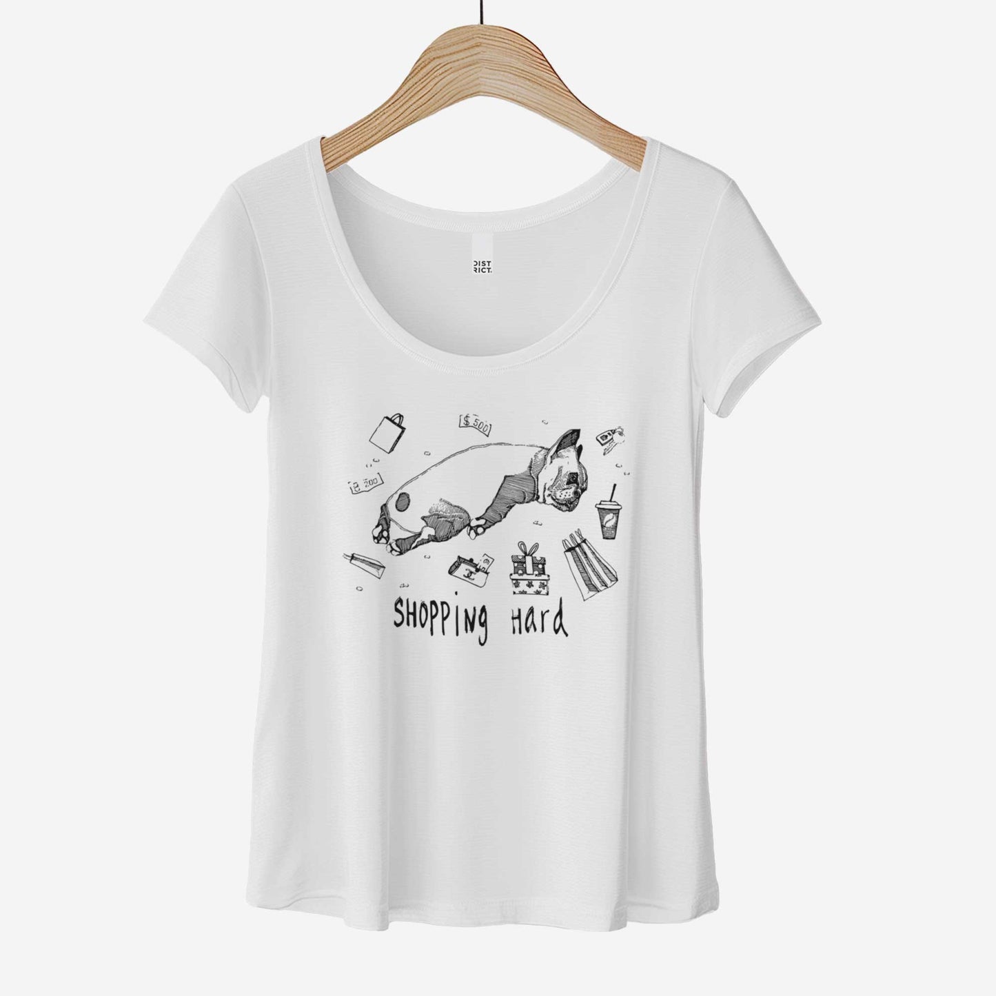 A white District 7501 scoop neck t-shirt featuring a tired French Bulldog laying among money and packages from a shopping spree.