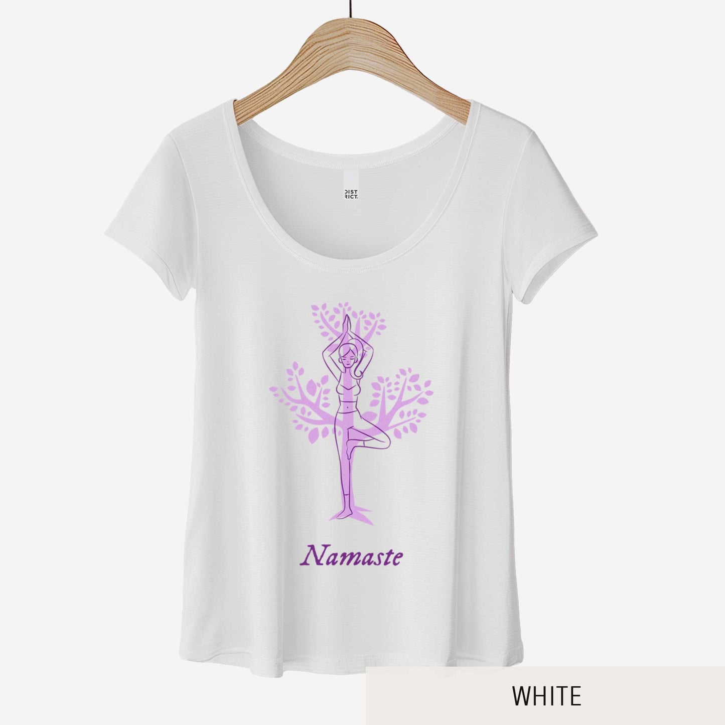 A hanging white District 7501 scoop neck t-shirt featuring a cartoon woman doing the tree pose in front of a tree silhouette and the words namaste below her.