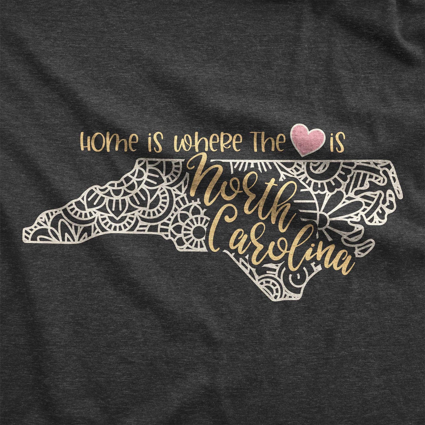 A dark grey heather Bella Canvas swatch featuring a mandala in the shape of North Carolina with the words home is where the heart is.