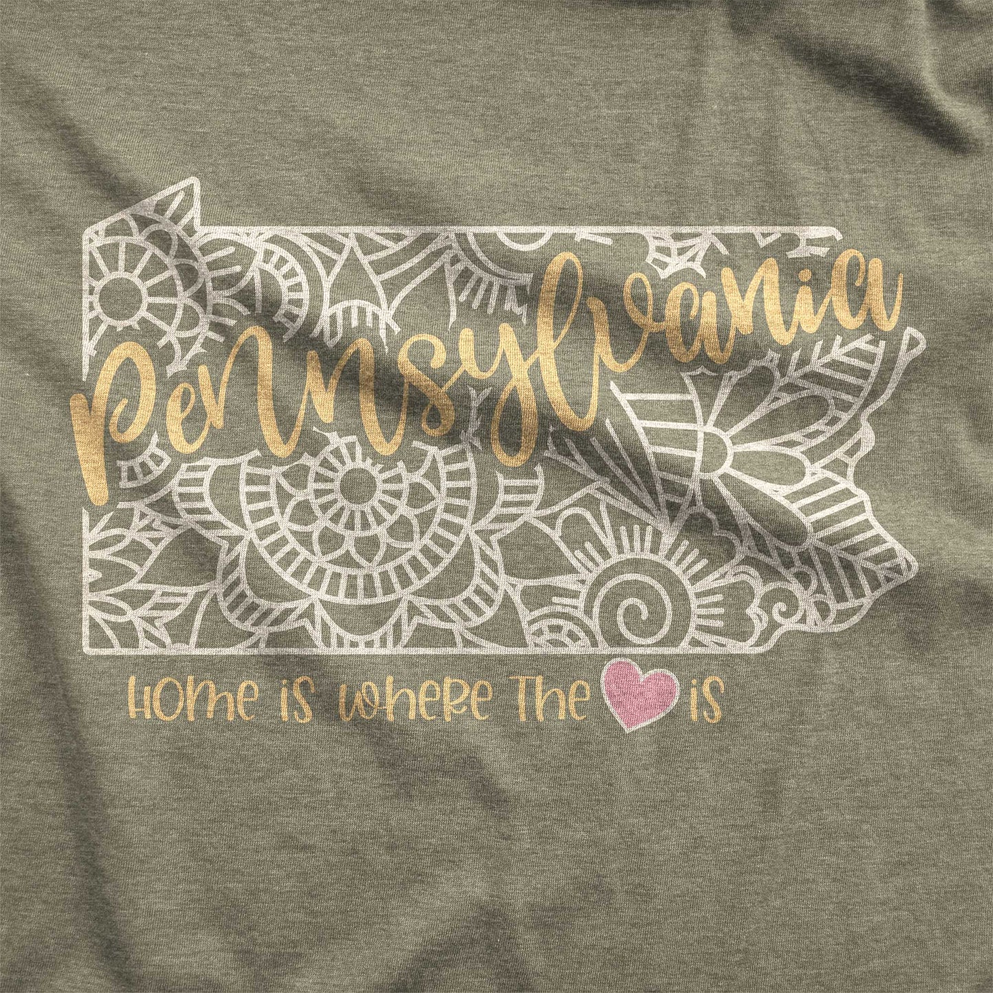 A heather olive Bella Canvas swatch featuring a mandala in the shape of Pennsylvania with the words home is where the heart is.
