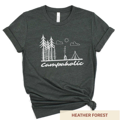 A heather forest Bella Canvas t-shirt surrounded by hiking gear featuring a tent, trees and the words campaholic.