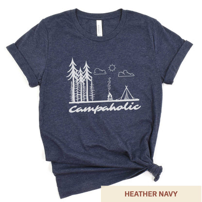 A heather navy Bella Canvas t-shirt surrounded by hiking gear featuring a tent, trees and the words campaholic.