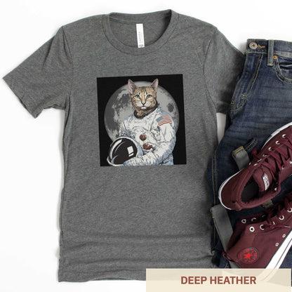 A deep heather grey Bella Canvas t-shirt featuring an illustrated portrait of a cat as a NASA astronaut with the moon in the background.