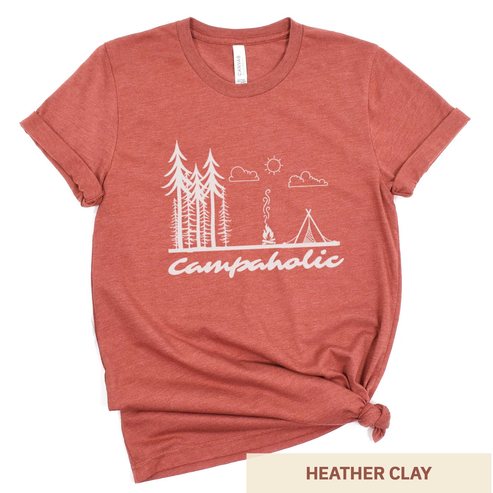 A heather clay Bella Canvas t-shirt surrounded by hiking gear featuring a tent, trees and the words campaholic.