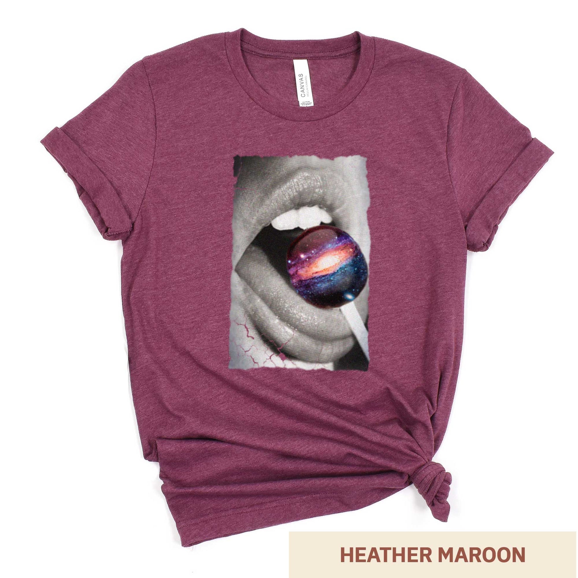 A heather maroon Bella Canvas t-shirt with a black and white image of a woman's mouth eating a lollipop that looks like a swirling galaxy.