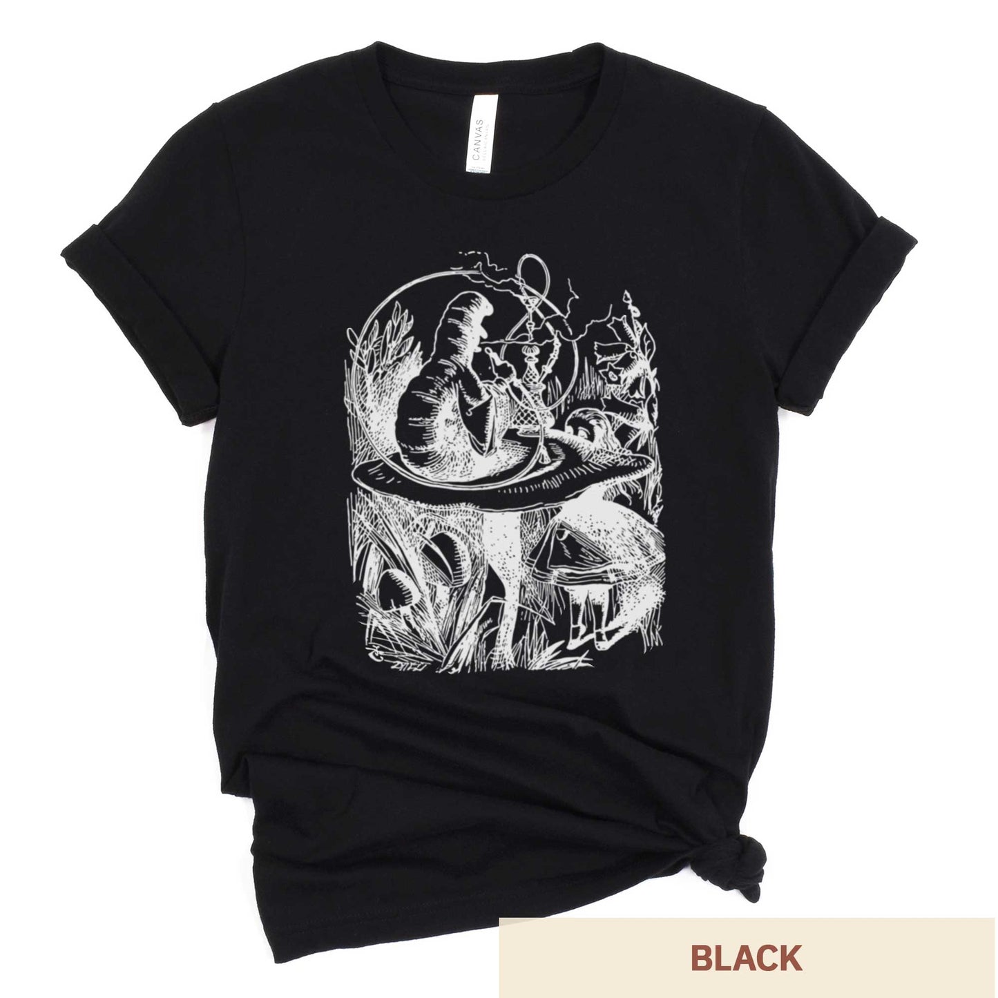 A black Bella Canvas t-shirt featuring the John Tenniel illustration of Alice in Wonderland meeting the caterpillar who is sitting on a mushroom.
