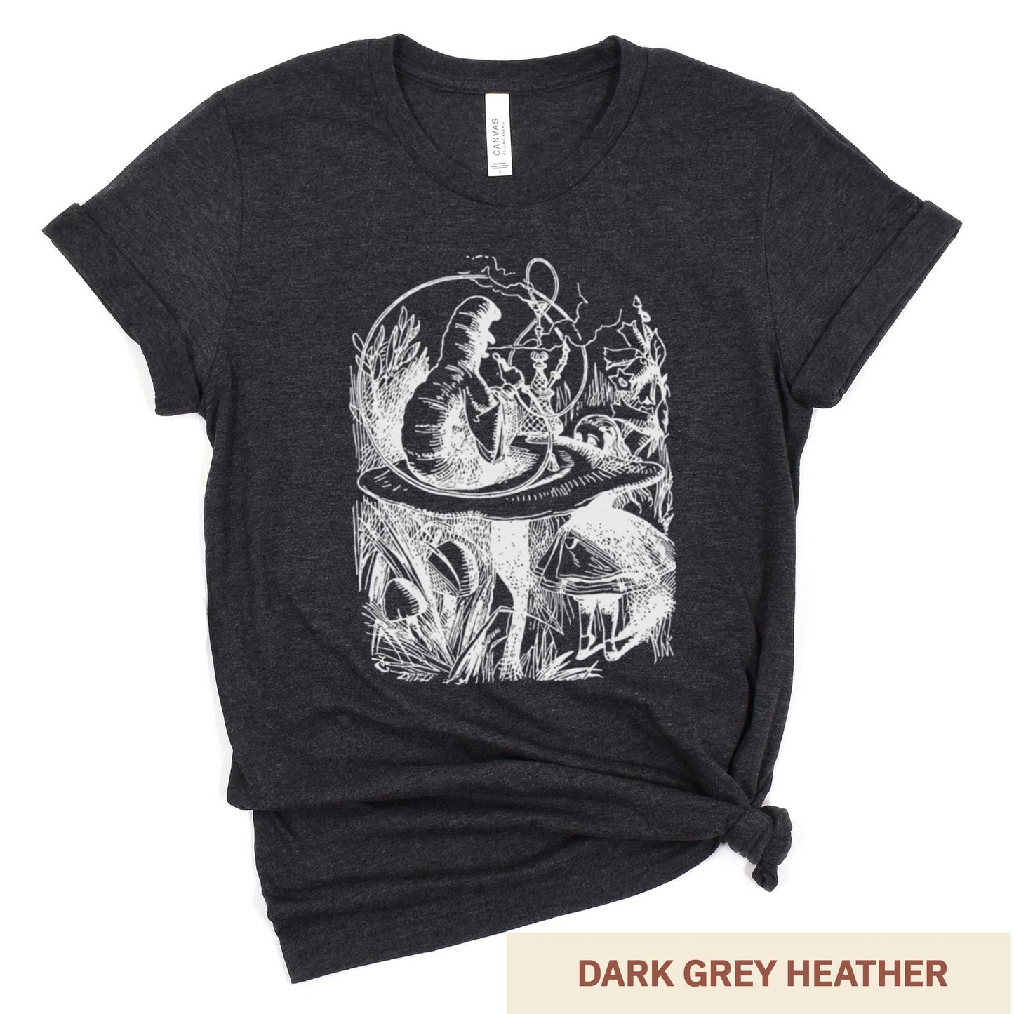 A dark grey heather Bella Canvas t-shirt featuring the John Tenniel illustration of Alice in Wonderland meeting the caterpillar who is sitting on a mushroom.