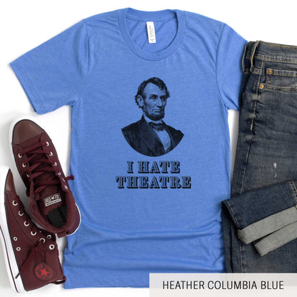 A heather columbia blue Bella Canvas t-shirt featuring a vintage illustration of Abraham Lincoln with the words I hate theatre below it.