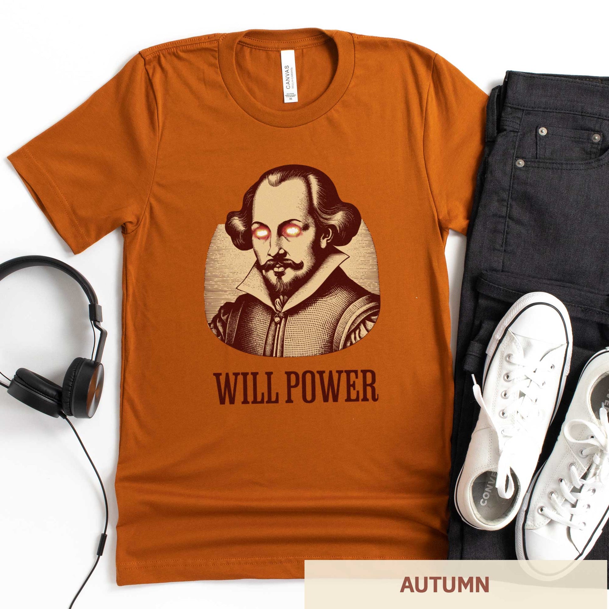 An autumn orange Bella Canvas t-shirt featuring a woodcut of William Shakespeare with glowing superhero eyes and the words Will Power.