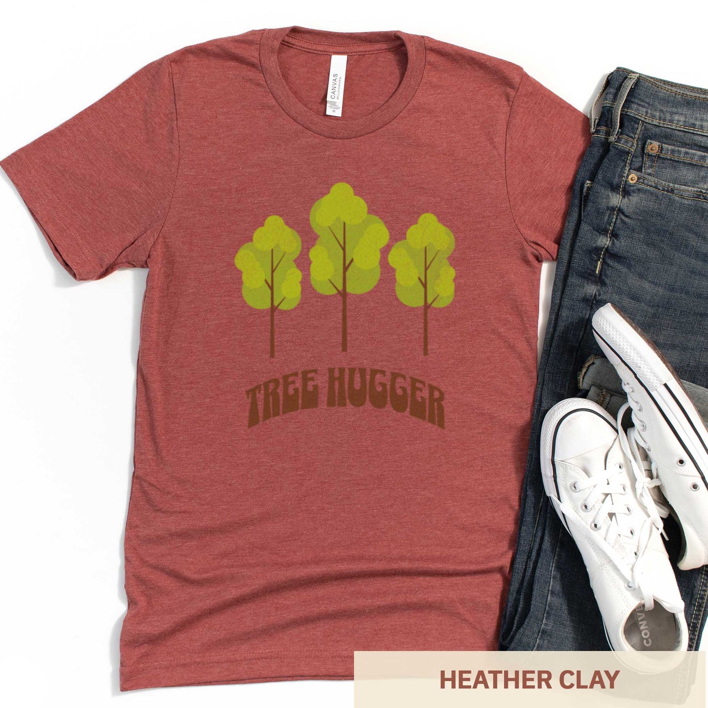 A heather clay Bella Canvas t-shirt featuring three trees and the words tree hugger.