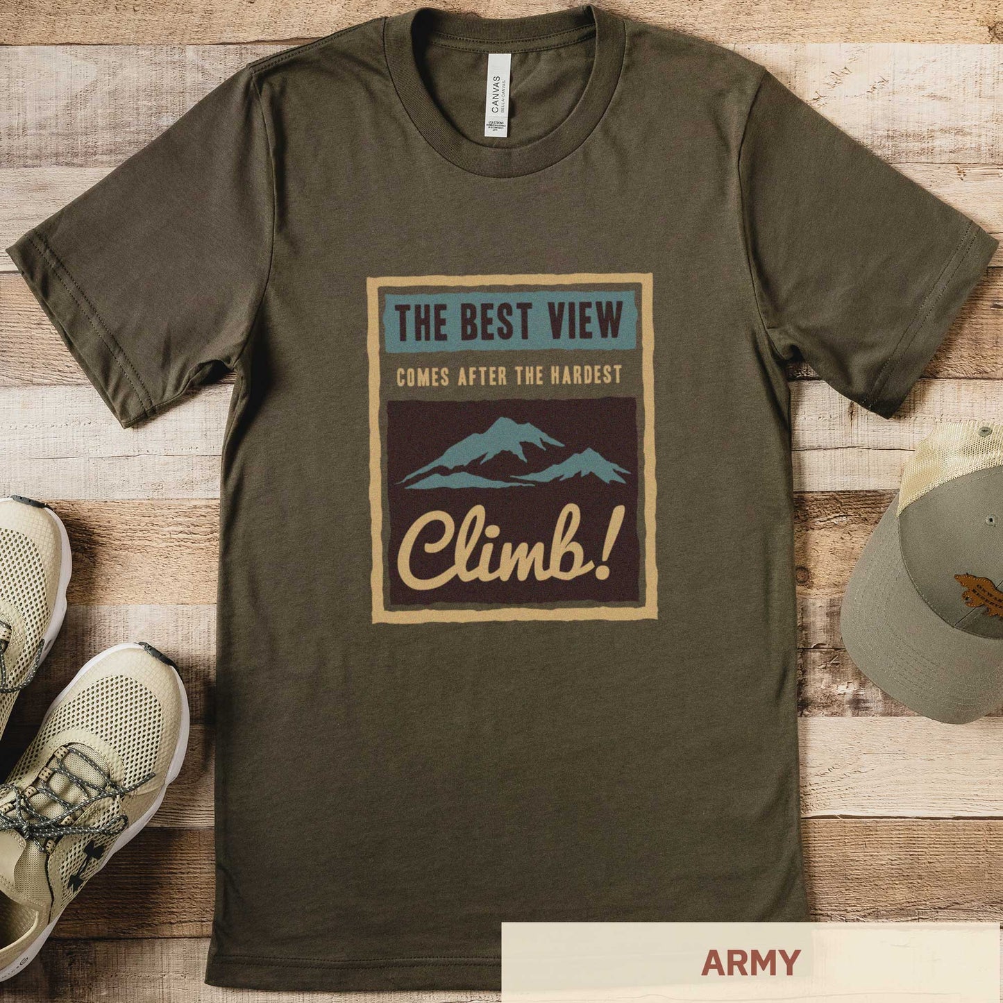 An army green Bella Canvas t-shirt that features mountains and the words the best view comes after the hardest climb.
