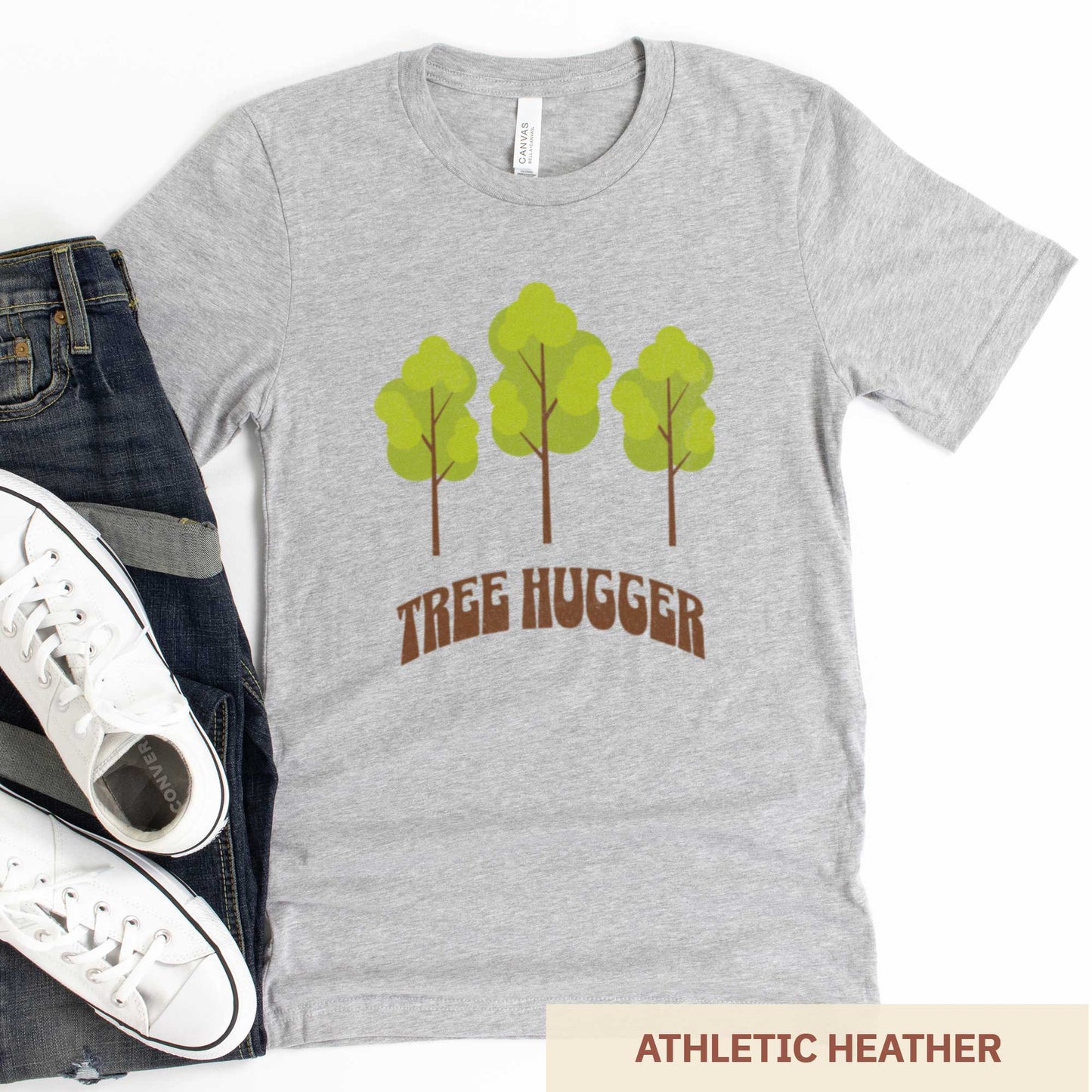 An athletic heather Bella Canvas t-shirt featuring three trees and the words tree hugger.