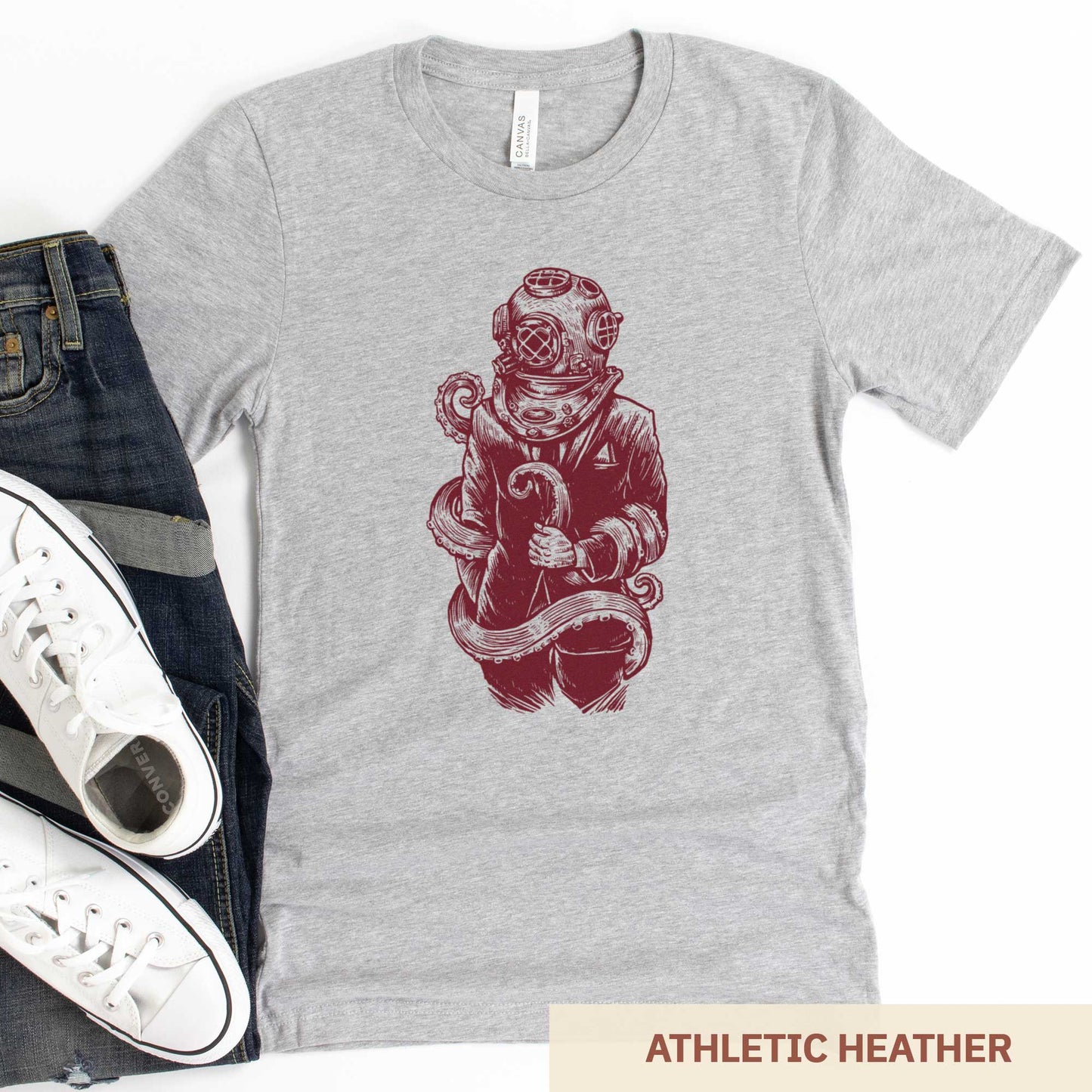 An athletic heather Bella Canvas t-shirt featuring a figure in a business suit wearing a vintage diver's helmet with octopus tentacles wrapped around them.
