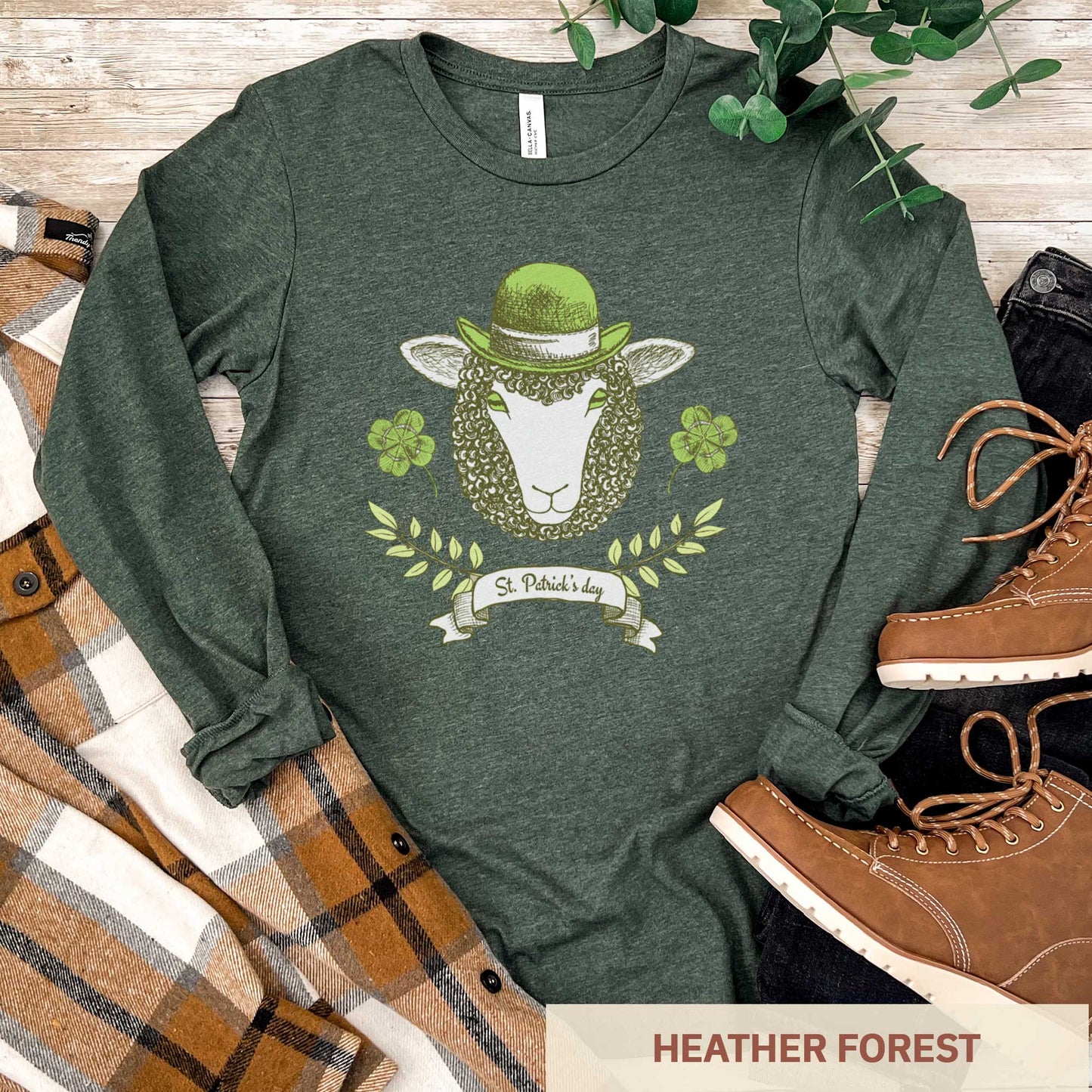 A long sleeved heather forest Bella Canvas t-shirt featuring a sheep with a green hat, clovers and the words St.Patrick's Day.