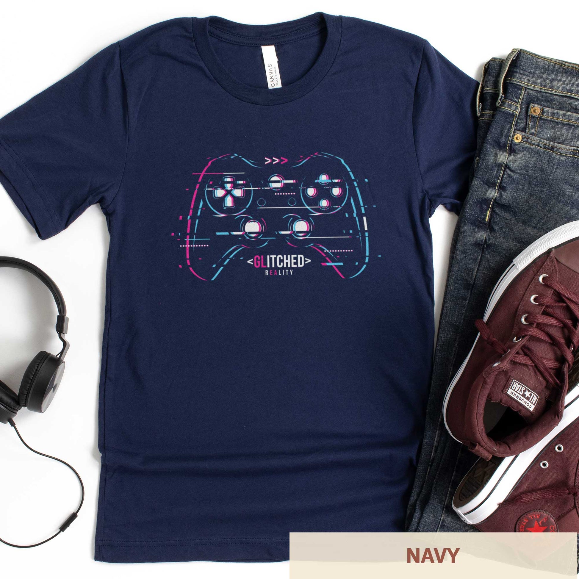 A navy Bella Canvas t-shirt with a glitchcore video game controller with the words glitched reality.