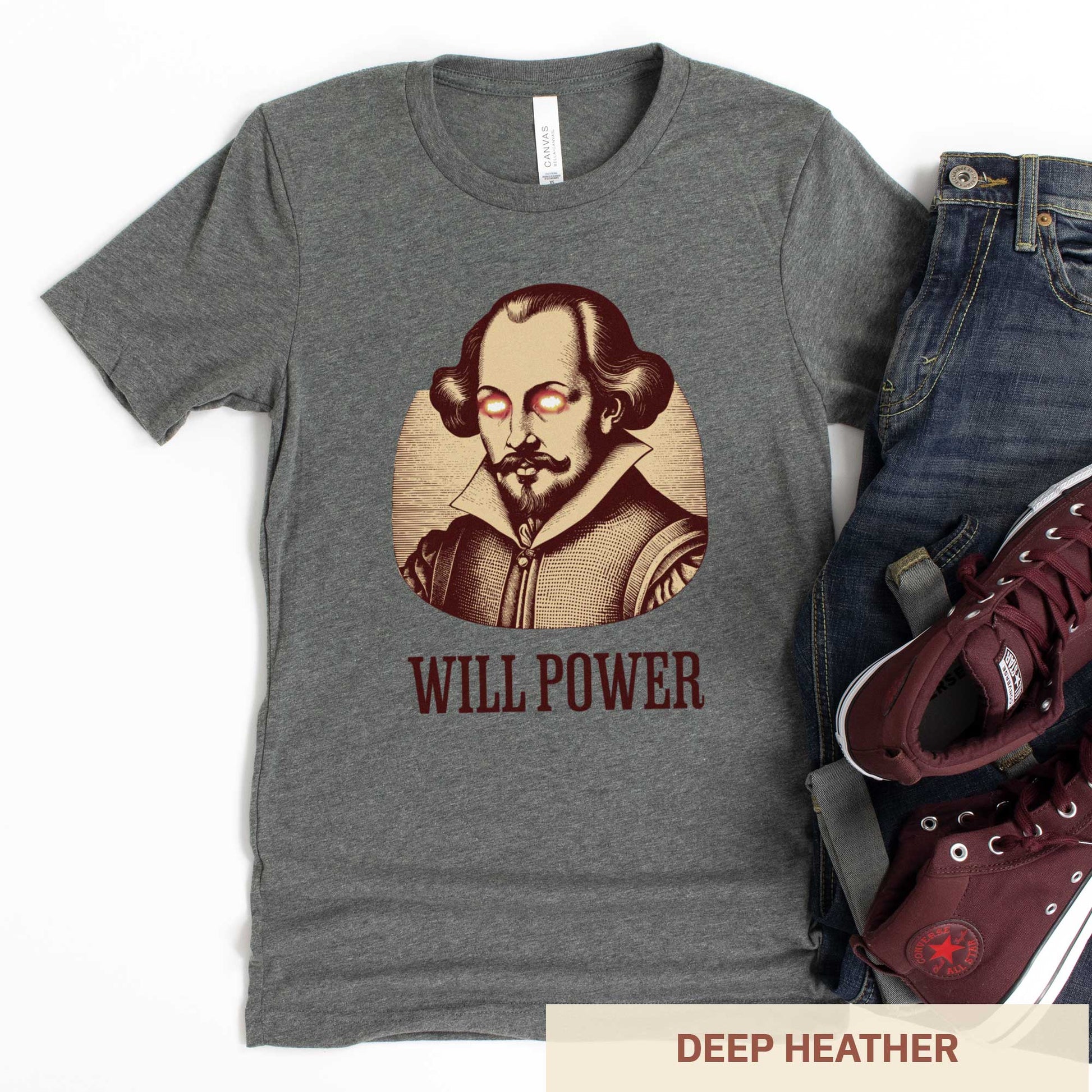 A deep heather grey Bella Canvas t-shirt featuring a woodcut of William Shakespeare with glowing superhero eyes and the words Will Power.