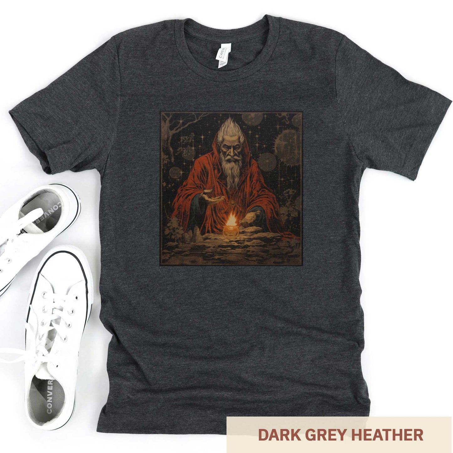 A dark grey heather Bella Canvas t-shirt featuring a medieval looking sourcerer casting a spell over a small open flame.