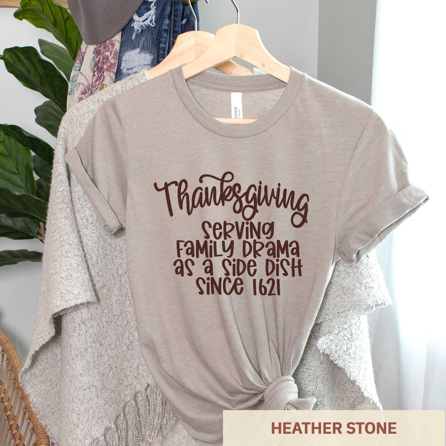 A hanging heather stone Bella Canvas t-shirt featuring the words thanksgiving serving family as a side dish since 1621.