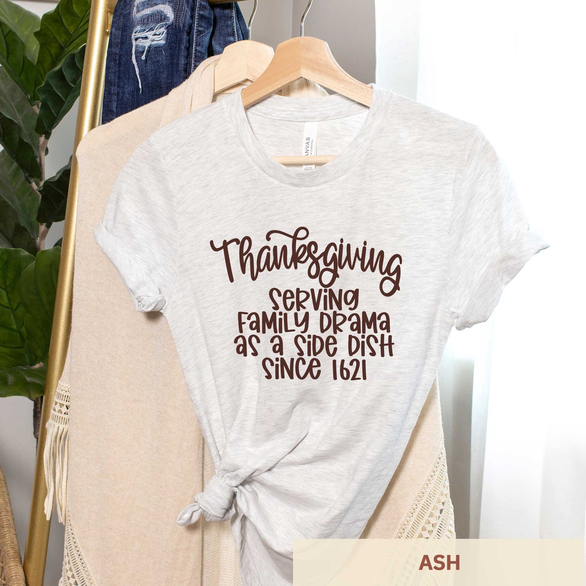 A hanging ash Bella Canvas t-shirt featuring the words thanksgiving serving family as a side dish since 1621.