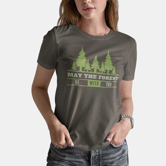 A woman wearing an army green Bella Canvas t-shirt featuring a silhouette of trees and the words may the forest be with you.