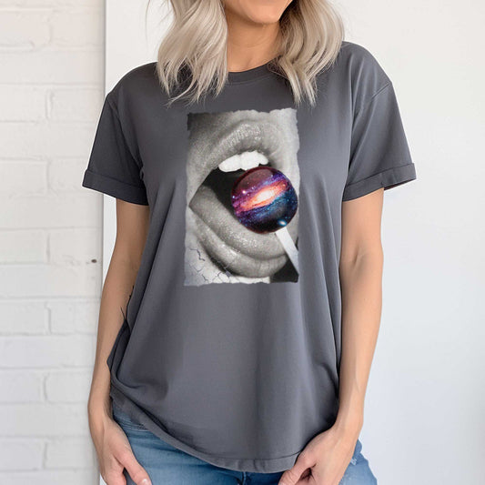 A woman wearing an asphalt grey Bella Canvas t-shirt with a black and white image of a woman's mouth eating a lollipop that looks like a swirling galaxy.