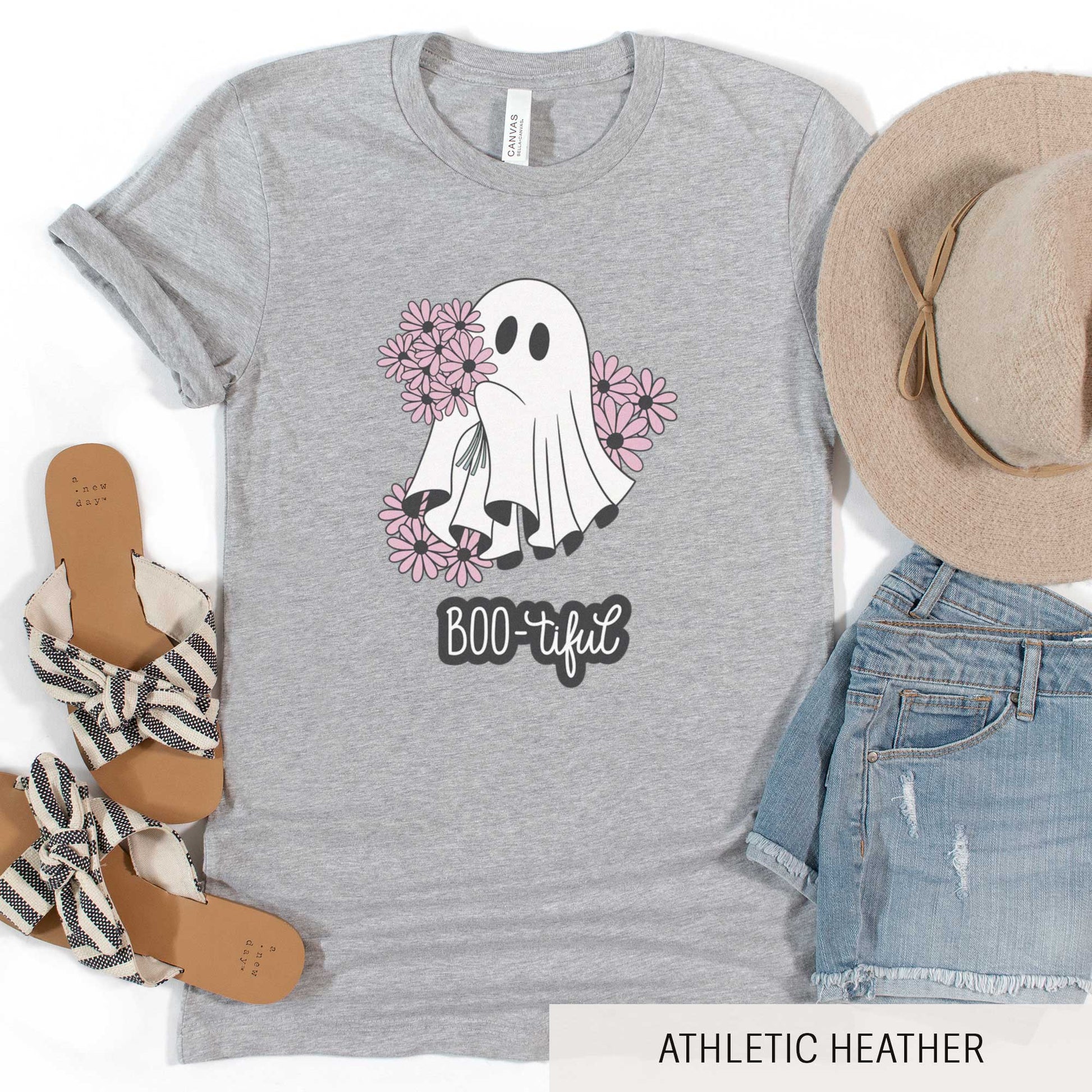 An athletic heather Bella Canvas t-shirt featuring a cute cartoon ghost surrounded by flowers and the words boo-tiful.