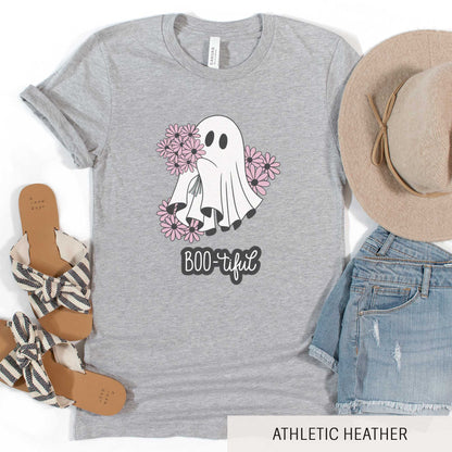 An athletic heather Bella Canvas t-shirt featuring a cute cartoon ghost surrounded by flowers and the words boo-tiful.