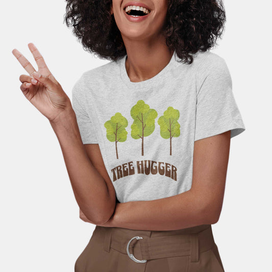 A woman wearing an athletic heather Bella Canvas t-shirt featuring three trees and the words tree hugger.
