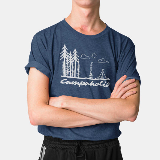 A man wearing a heather navy Bella Canvas t-shirt featuring a tent, trees and the words campaholic.