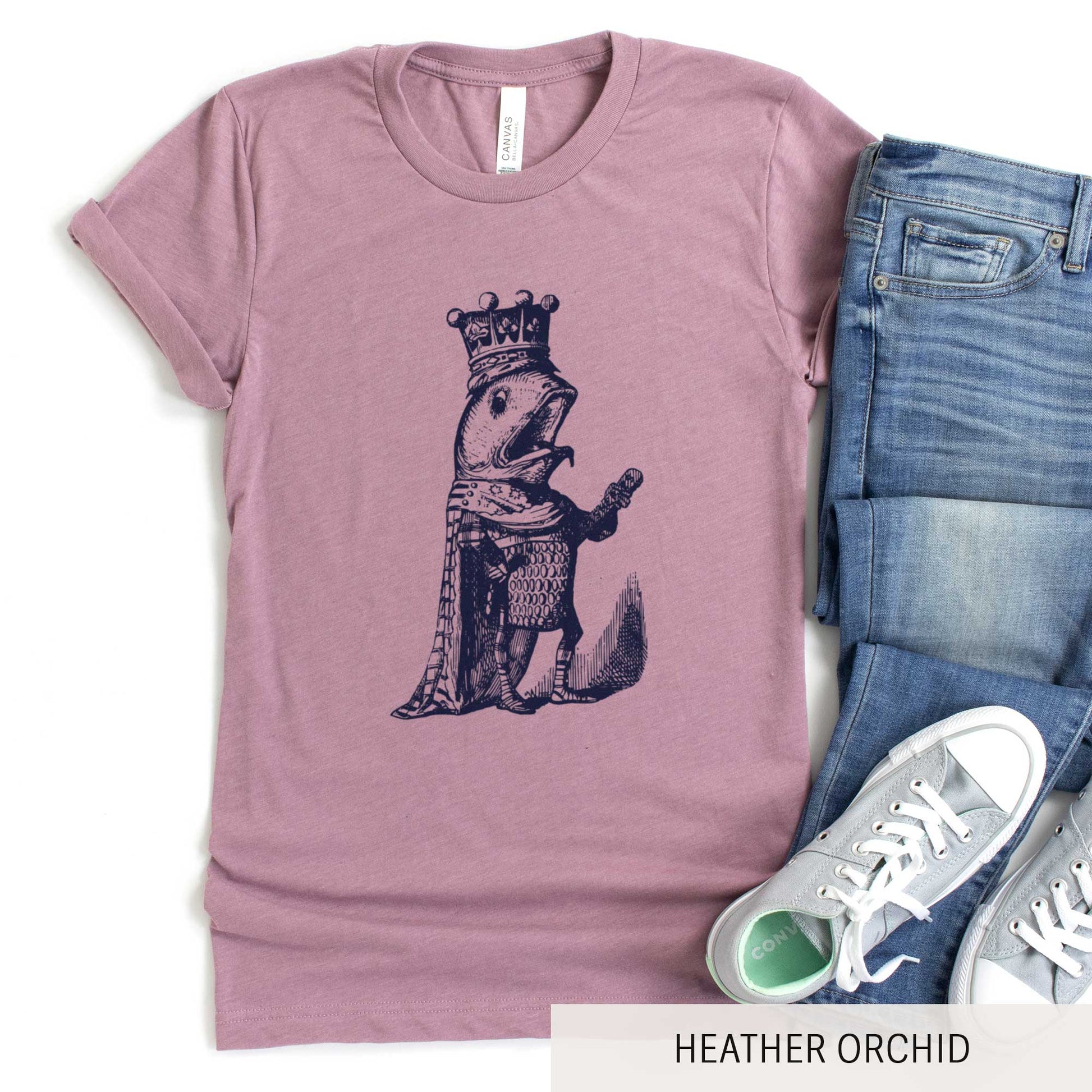 A heather orchid Bella Canvas t-shirt featuring a vintage illustration of a talking fish dressed in the royal robes of a king.