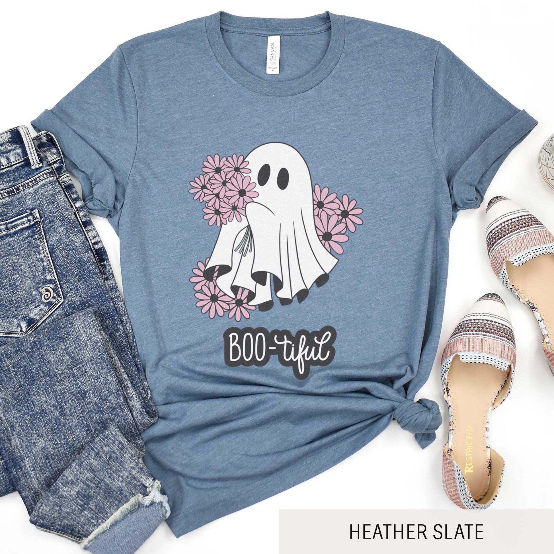 A heather slate Bella Canvas t-shirt featuring a cute cartoon ghost surrounded by flowers and the words boo-tiful.