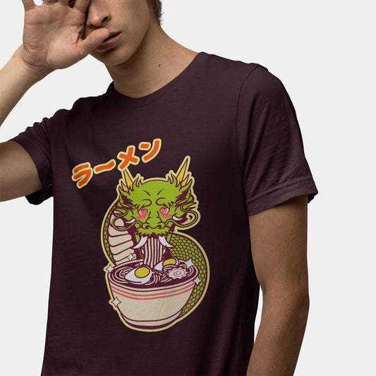 A man wearing an oxblood black Bella Canvas t-shirt featuring a kawaii dragon eating ramen with the words ramen in japanese above it.