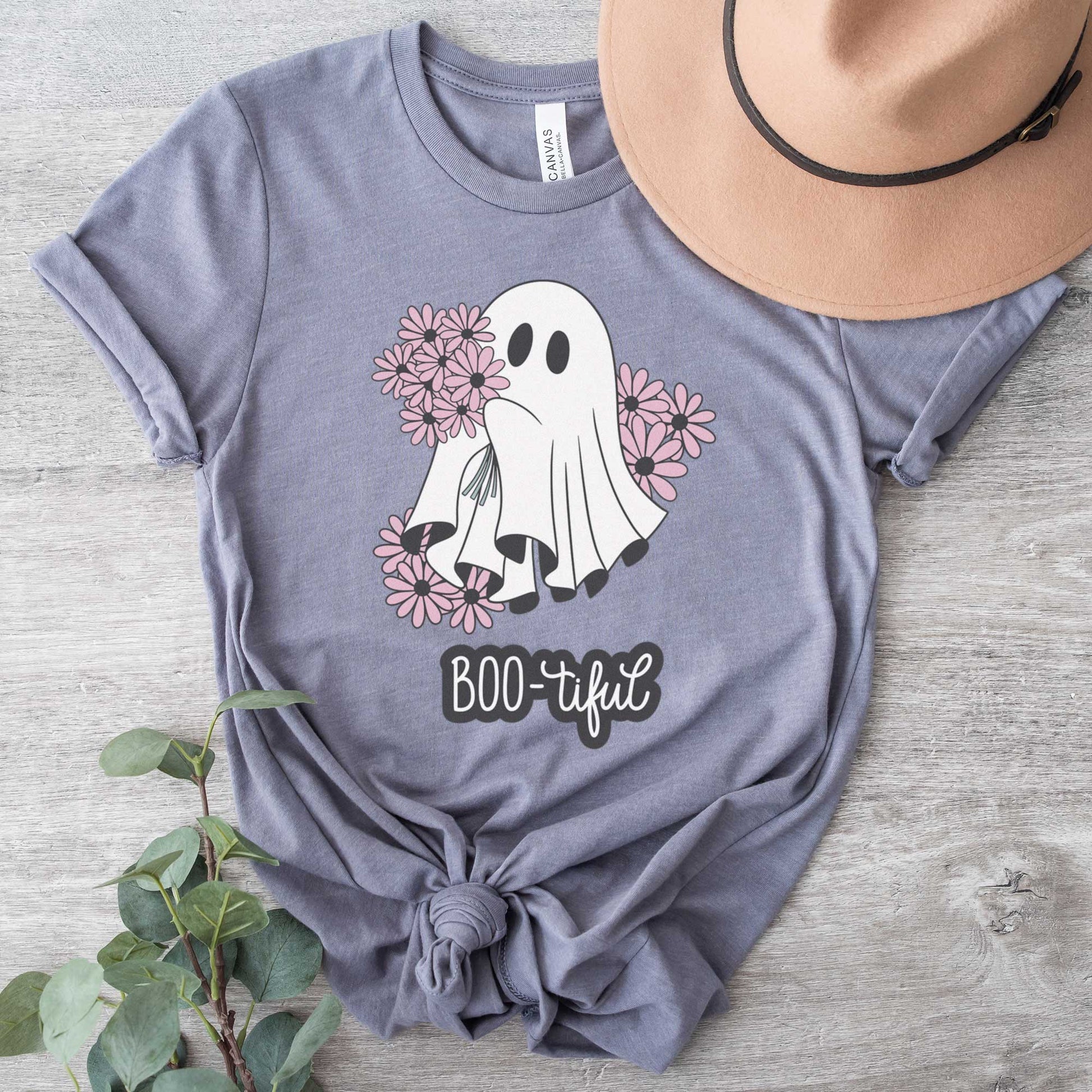 A storm Bella Canvas t-shirt featuring a cute cartoon ghost surrounded by flowers and the words boo-tiful.