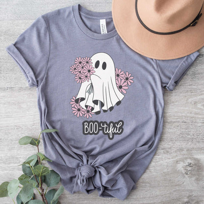 A storm Bella Canvas t-shirt featuring a cute cartoon ghost surrounded by flowers and the words boo-tiful.