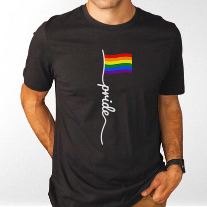 A man wearing a black Bella Canvas t-shirt featuring a LGBTQ rainbow flag with the words pride