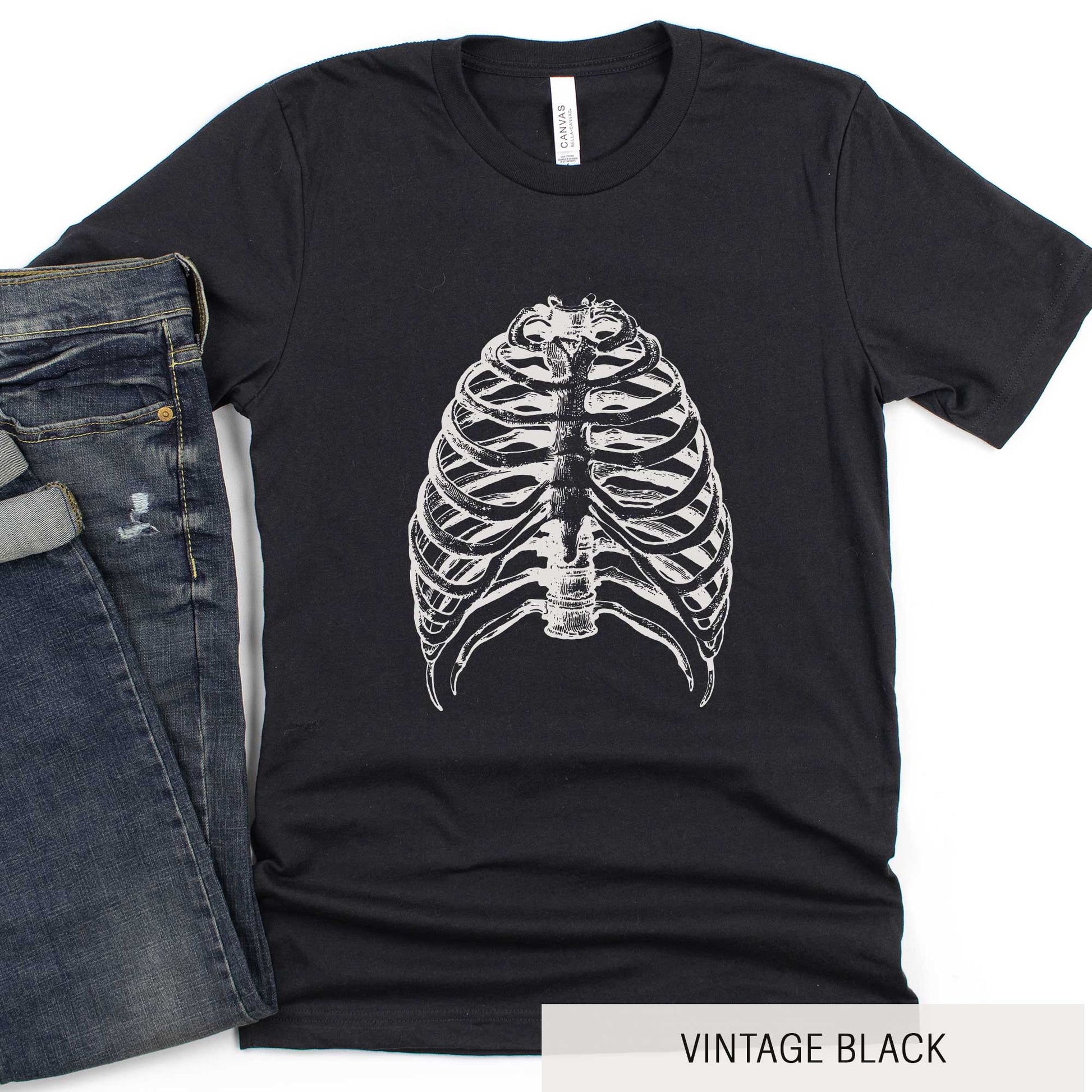 A vintage black Bella Canvas t-shirt featuring a vintage illustration of a skeletons rib cage.