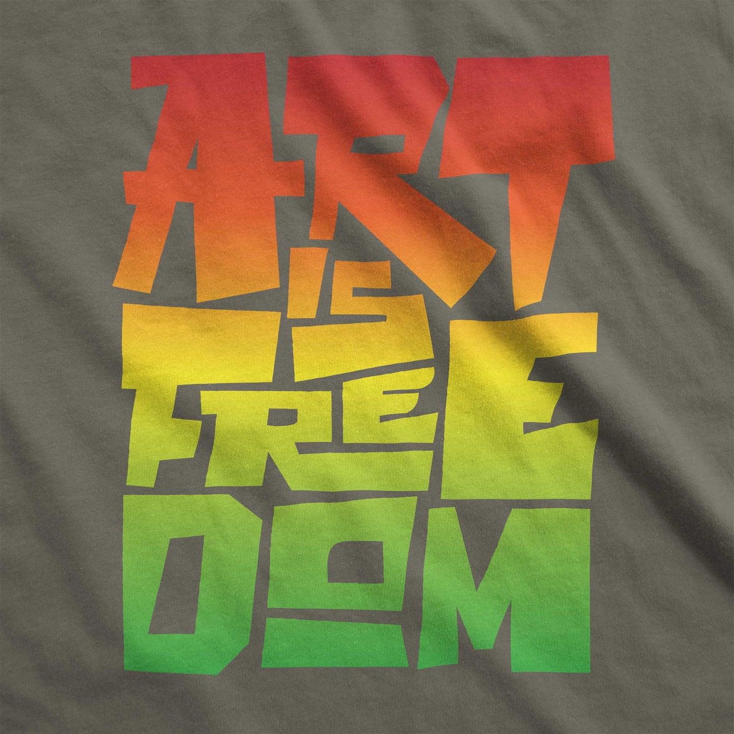 An army green Bella Canvas swatch that says art is freedom in a red, yellow and green gradient.