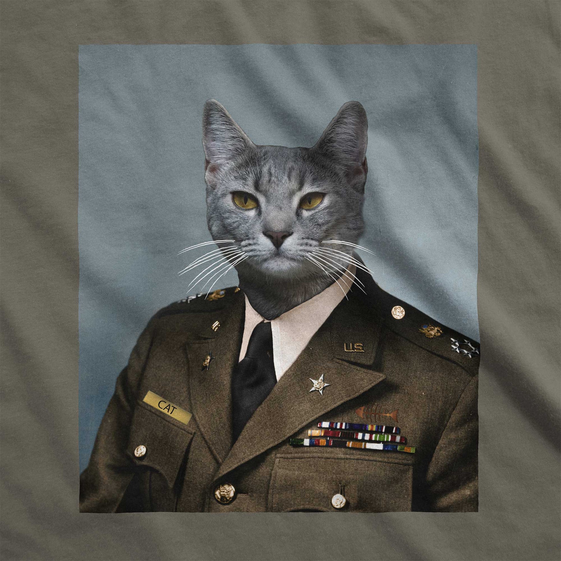 An army green Bella Canvas swatch with a portrait of a grey cat as a U.S. army general