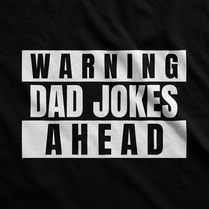 A black Bella Canvas swatch featuring the words warning dad jokes ahead.