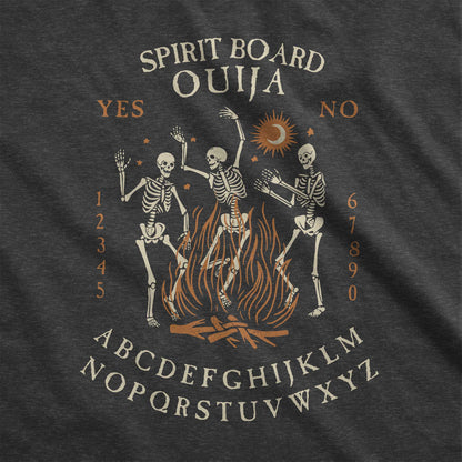 A dark grey heather Bella Canvas swatch with dancing skeletons in front of a fire and an ouija board layout.