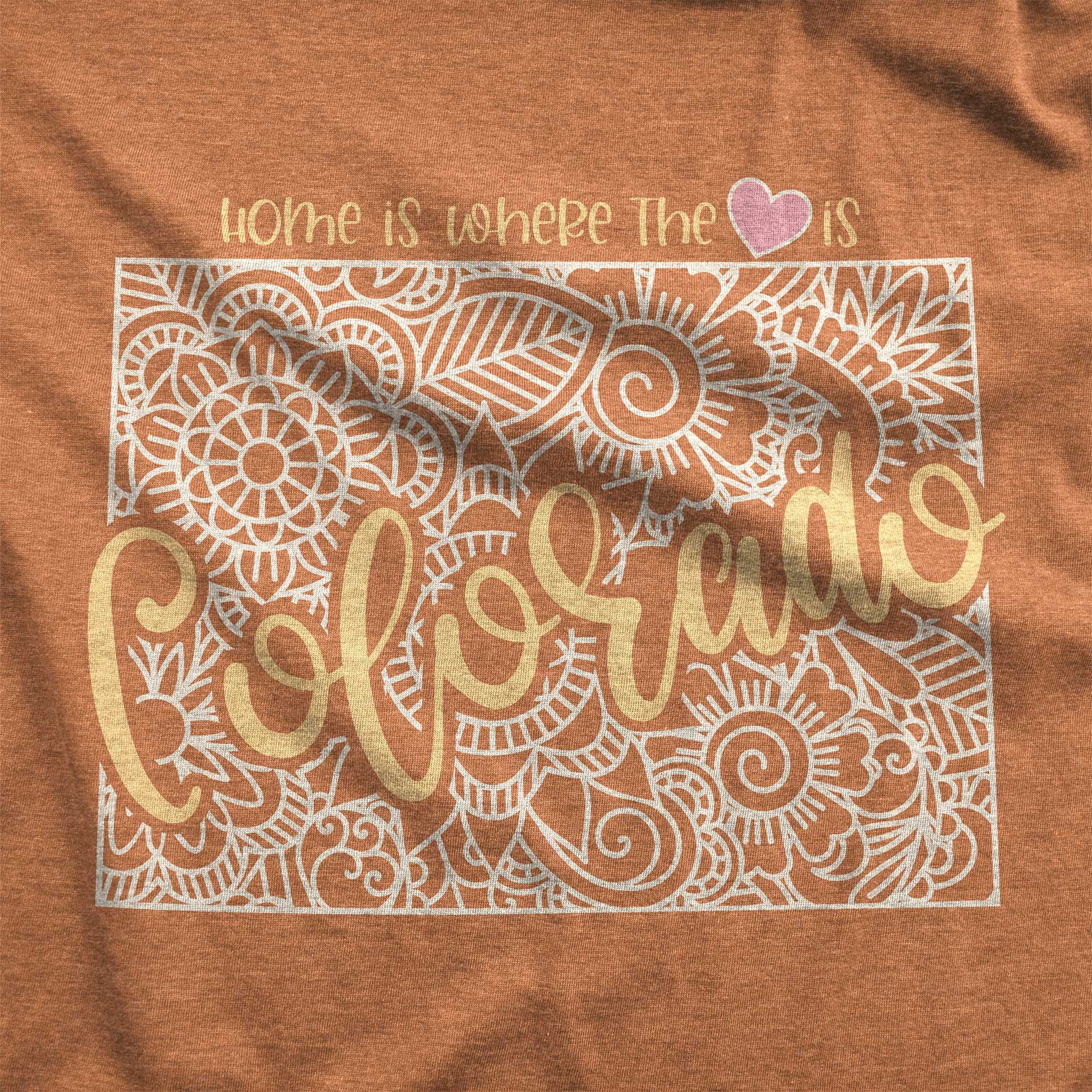  A heather autumn Bella Canvas swatch featuring a mandala in the shape of Colorado with the words home is where the heart is.