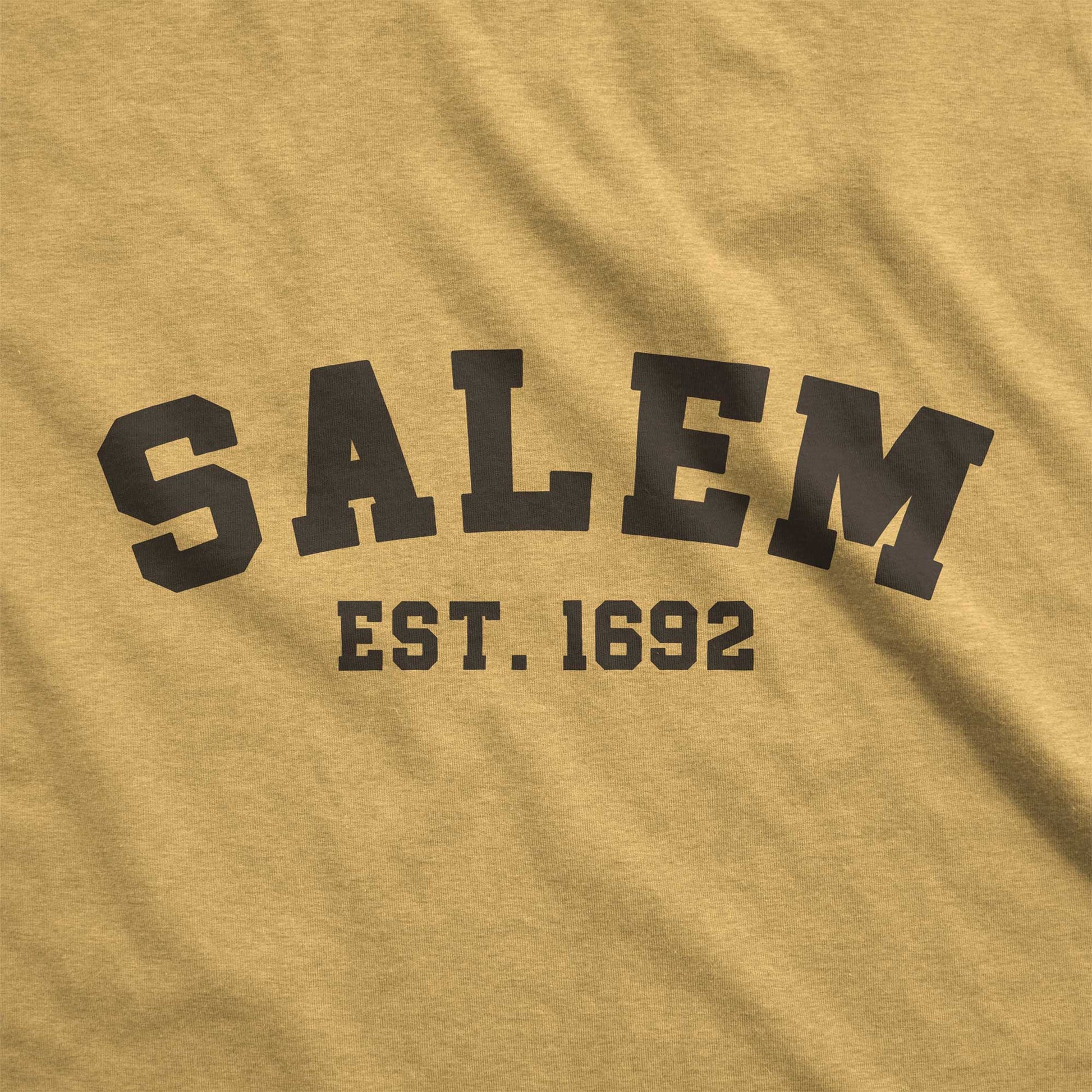 A mustard yellow Bella Canvas swatch that says Salem Est. 1692.