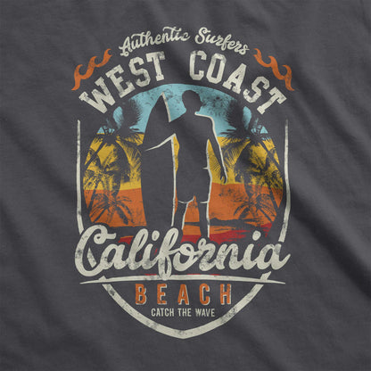 A pepper gray Comfort Colors swatch featuring a man standing on a beach with a surfboard in front of a multi-colored sunset with the words California Beach.