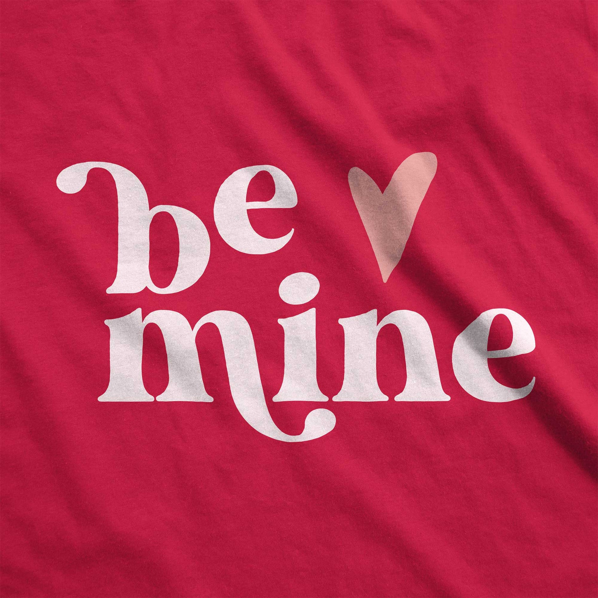 A red Bella Canvas swatch with the words be mine and a heart next to it.