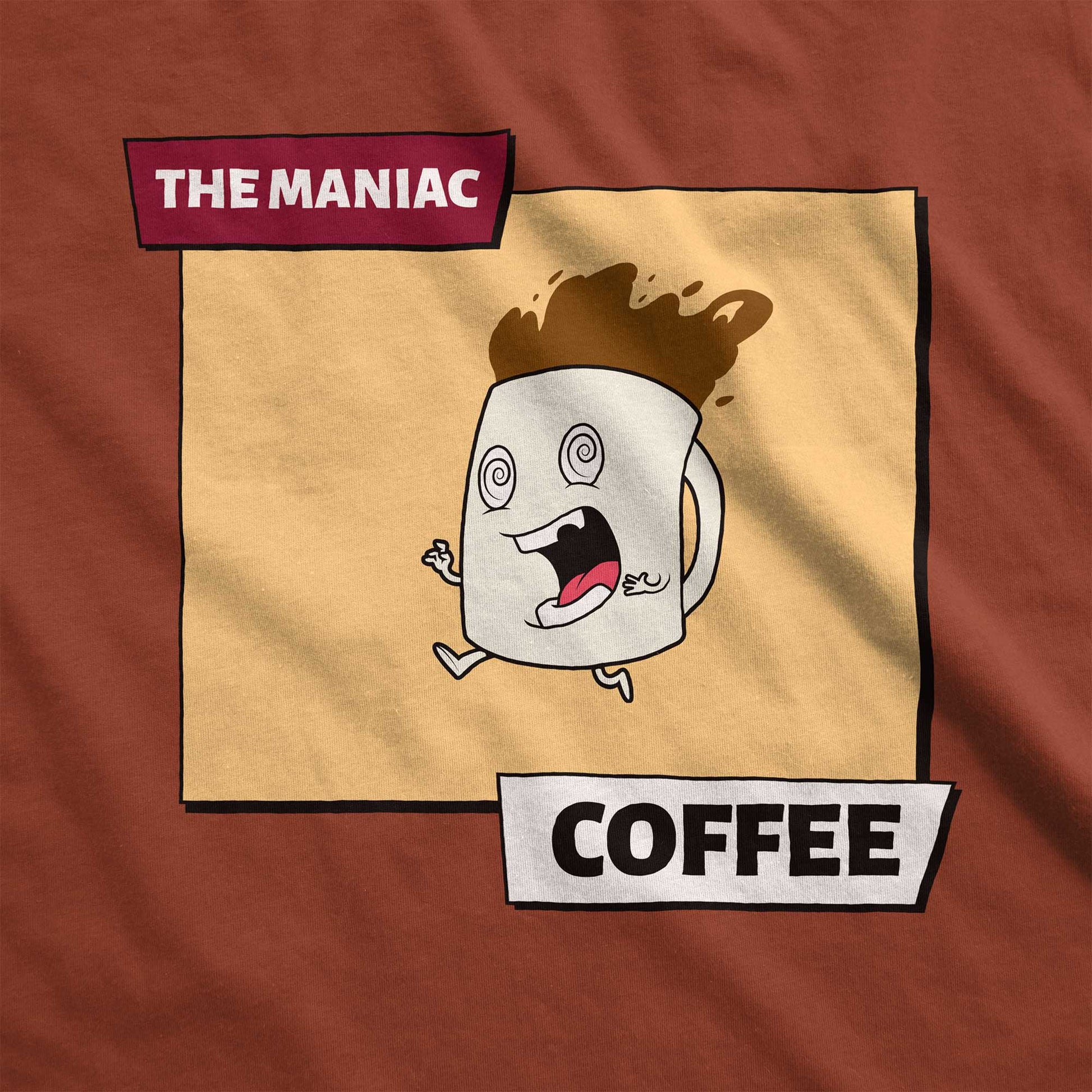 A rust orange Bella Canvas swatch featuring a cartoon of a crazed coffee mug with the words the maniac coffee