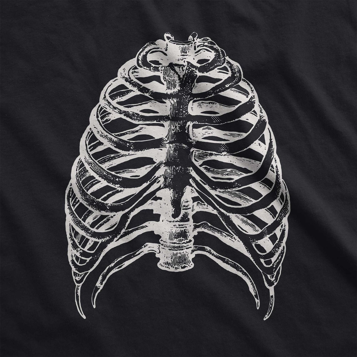 A vintage black Bella Canvas swatch featuring a vintage illustration of a skeletons rib cage.